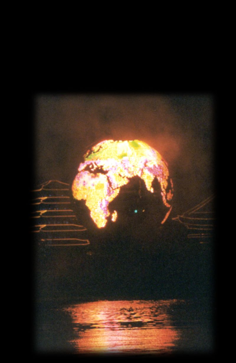 The Earth Globe lit at night, its continents glowing above the water