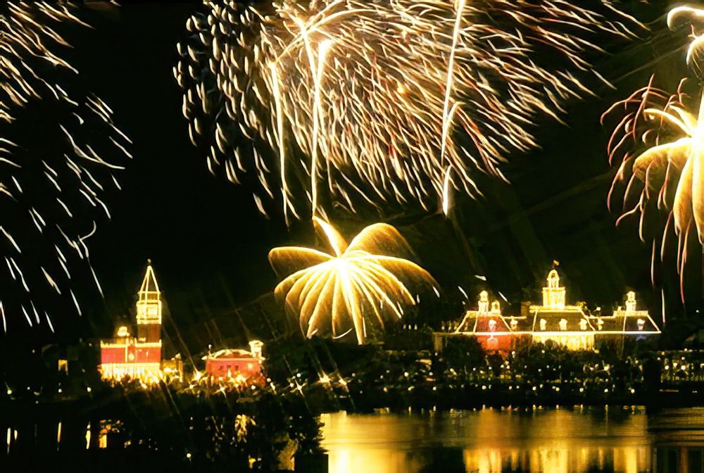 IllumiNations fireworks over the Epcot lagoon with the World Showcase pavilions lit below