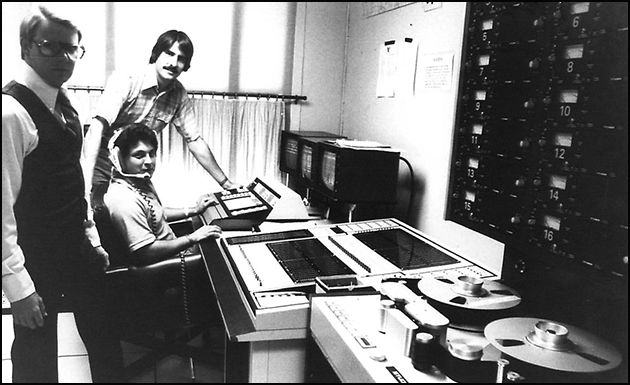 Engineers seated at the original Mickey Track parade-control console